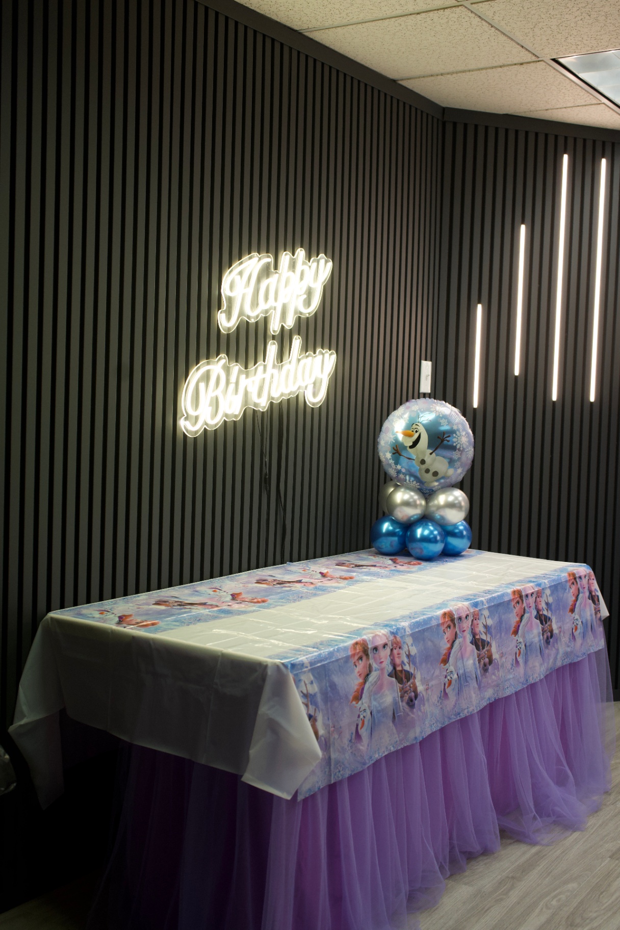 Neon Happy Birthday sign above a Frozen dessert table at Star Park Cherry Hill
