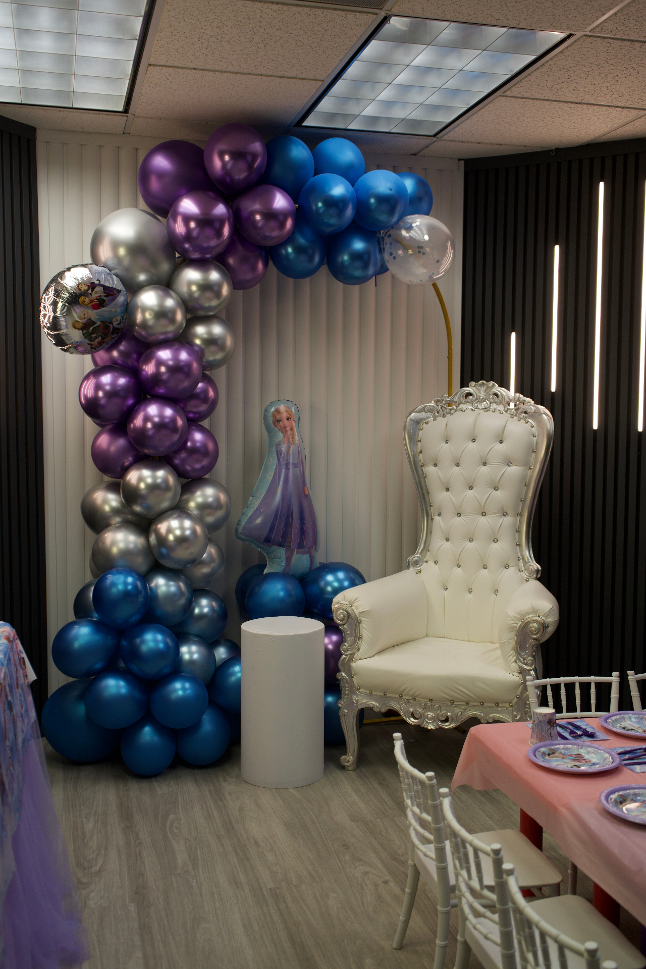White throne chair with purple, silver, and blue balloon arch at Star Park Cherry Hill
